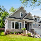 a front view of a house with a yard table and chairs