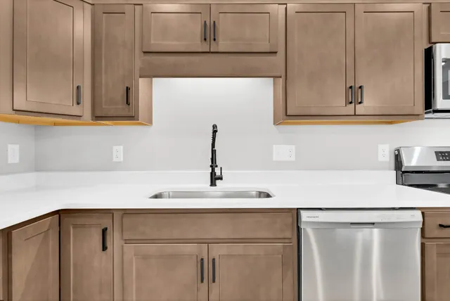 a kitchen with a sink and cabinets