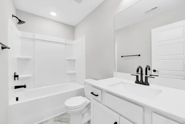 a bathroom with a sink a toilet and a bathtub