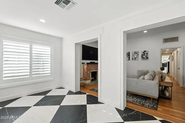 a kitchen with granite countertop kitchen island stainless steel appliances a dining table and chairs