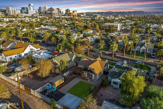 a view of a house with a big yard and a fountain