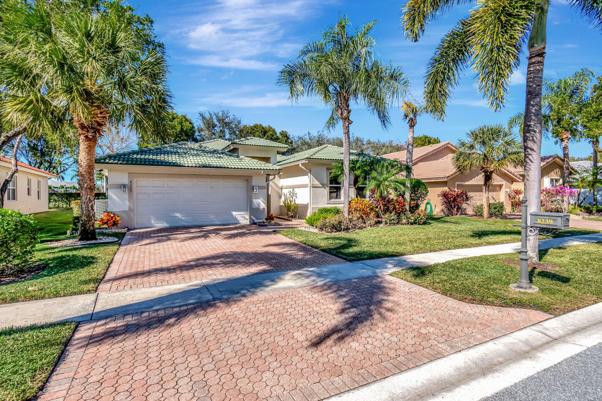 8239 Marsala Way Boynton Beach, FL 33472 - Photo 1 of 68 a front view of a house with garden