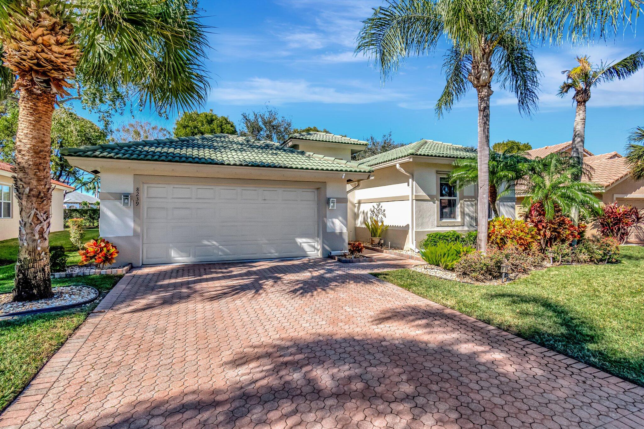 8239 Marsala Way Boynton Beach, FL 33472 - Photo 2 of 68 a view of a backyard with plants and palm trees