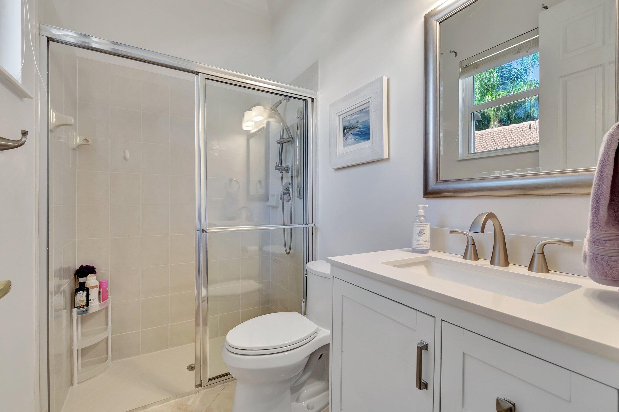8239 Marsala Way Boynton Beach, FL 33472 - Photo 29 of 68 a bathroom with a sink toilet and shower