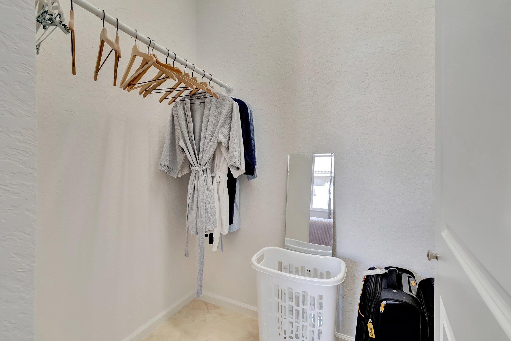 8239 Marsala Way Boynton Beach, FL 33472 - Photo 30 of 68 a view of walk in closet with clothes and shoes