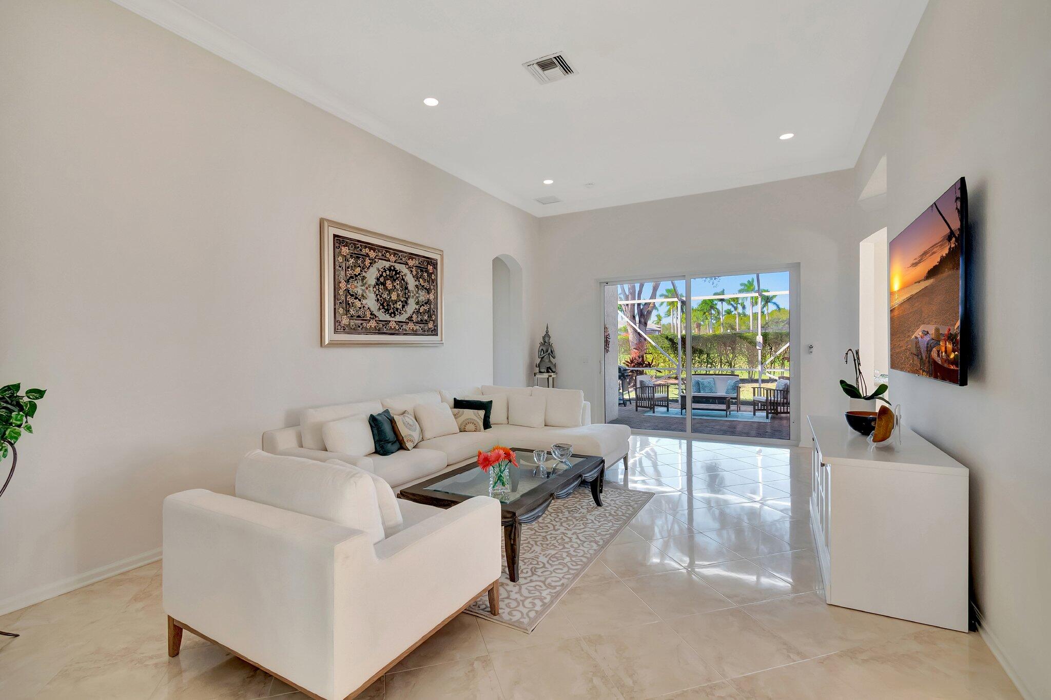 8239 Marsala Way Boynton Beach, FL 33472 - Photo 7 of 68 a living room with furniture and a flat screen tv