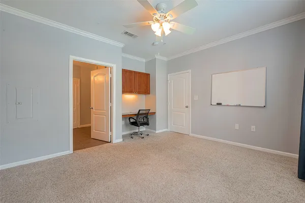 a view of a house with backyard water fountain and sitting area