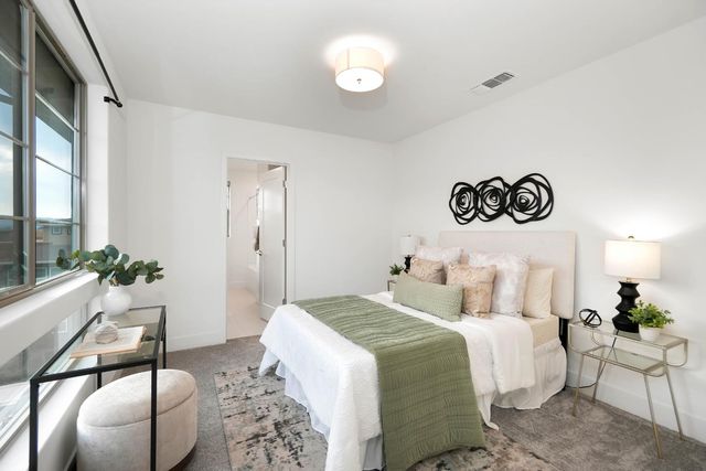 a bedroom with a bed and a couch