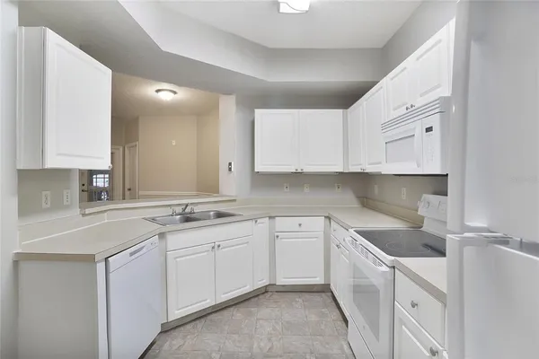 a kitchen with a sink cabinets and window