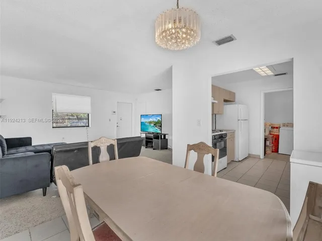 a large bedroom with furniture and a chandelier