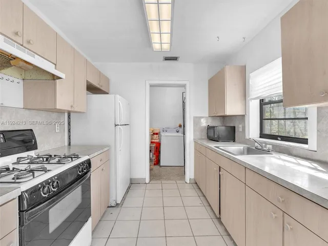a kitchen with a sink stove and refrigerator