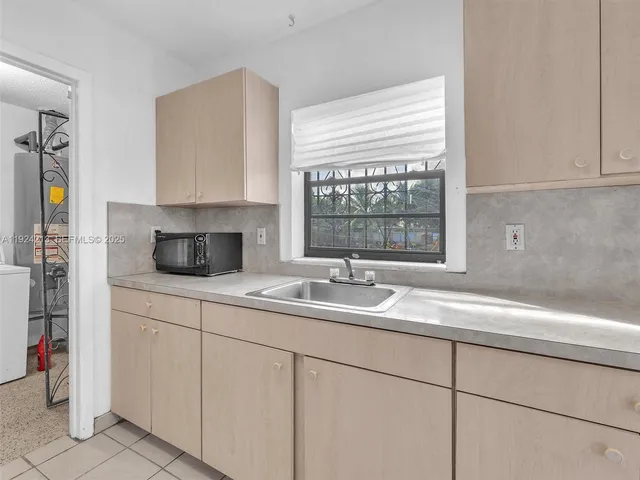 a kitchen with a sink and cabinets