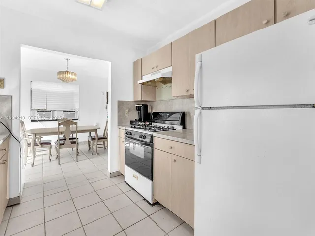 a kitchen with stainless steel appliances a refrigerator sink and cabinets