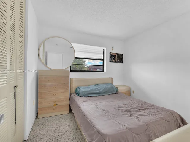 a bedroom with a bed and a mirror