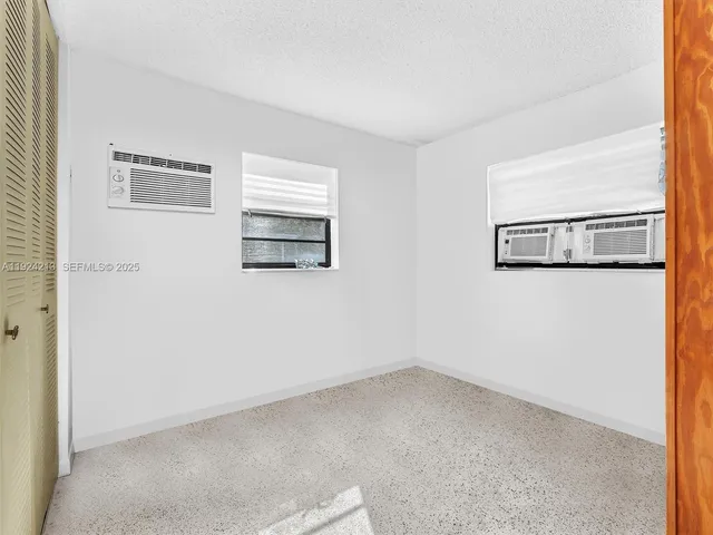 a view of a small space with wooden floor and a window
