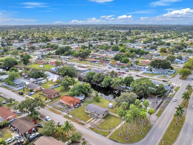 an aerial view of residential houses with outdoor space and seating