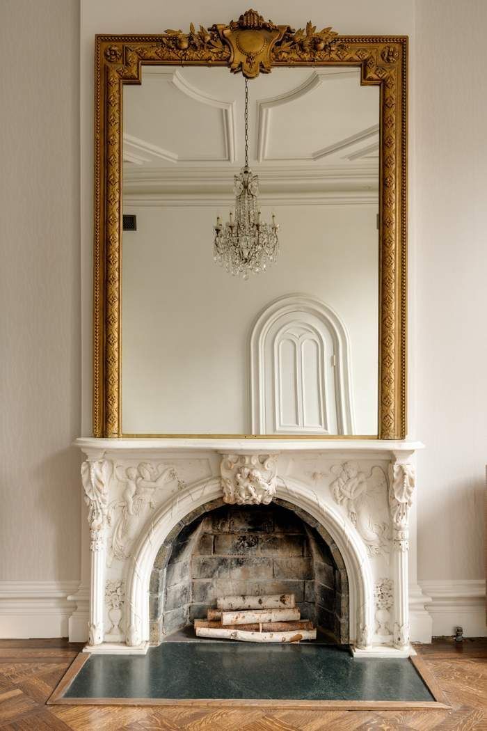 243 East 17th Street Manhattan, NY 10003 - Photo 16 of 44 a living room with a fireplace and a chandelier