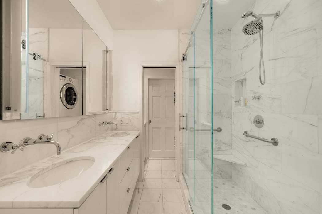 243 East 17th Street Manhattan, NY 10003 - Photo 25 of 44 a bathroom with a granite countertop sink mirror and shower