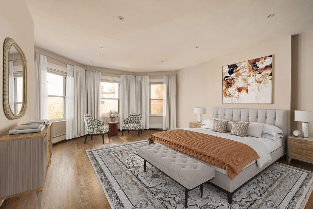 243 East 17th Street Manhattan, NY 10003 - Photo 30 of 44 a spacious bedroom with a bed a couch and windows