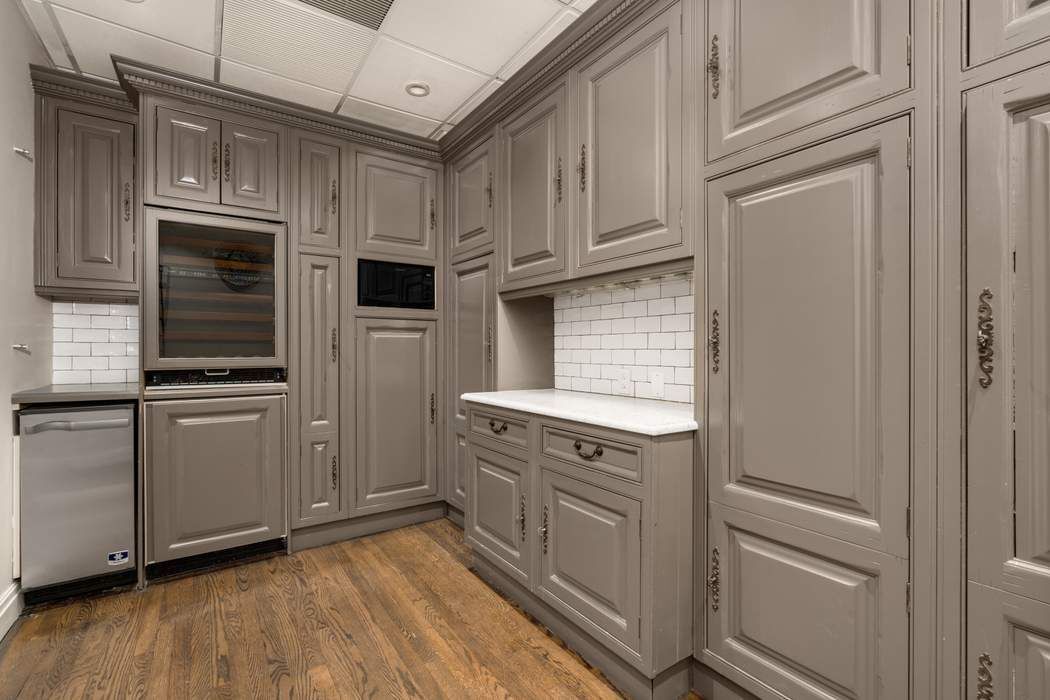 243 East 17th Street Manhattan, NY 10003 - Photo 9 of 44 a kitchen with stainless steel appliances granite countertop a refrigerator and a stove top oven