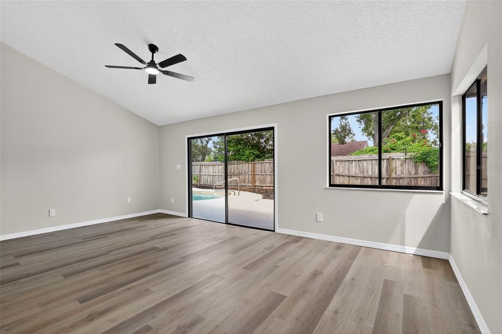 3441 Calgary Lane Mount Dora, FL 32757 - Photo 11 of 20 a view of empty room with wooden floor and fan