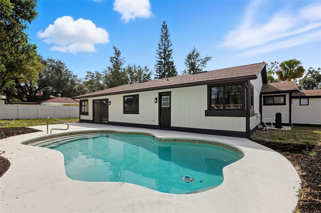 3441 Calgary Lane Mount Dora, FL 32757 - Photo 19 of 20 a view of a house with swimming pool and a yard