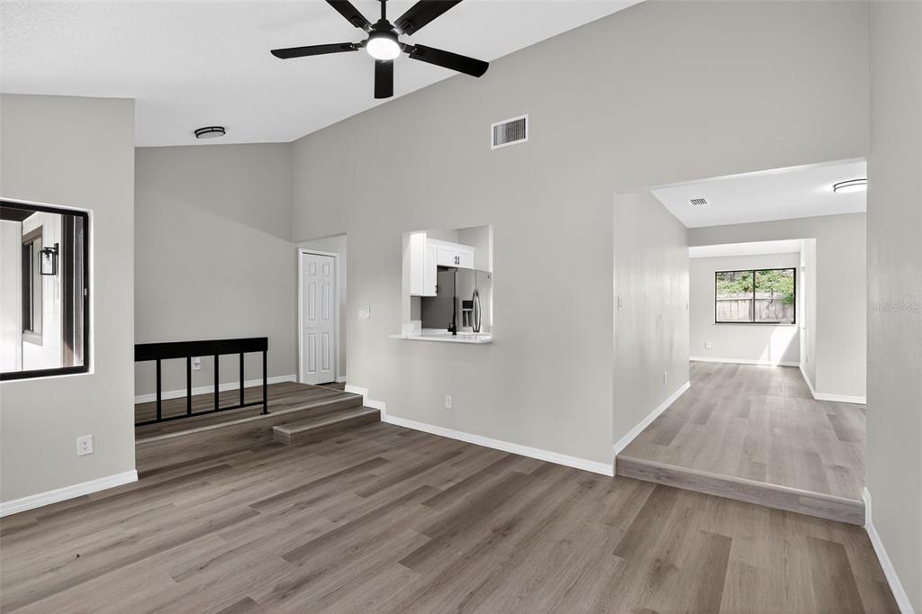 3441 Calgary Lane Mount Dora, FL 32757 - Photo 4 of 20 a view of a livingroom with wooden floor and a ceiling fan