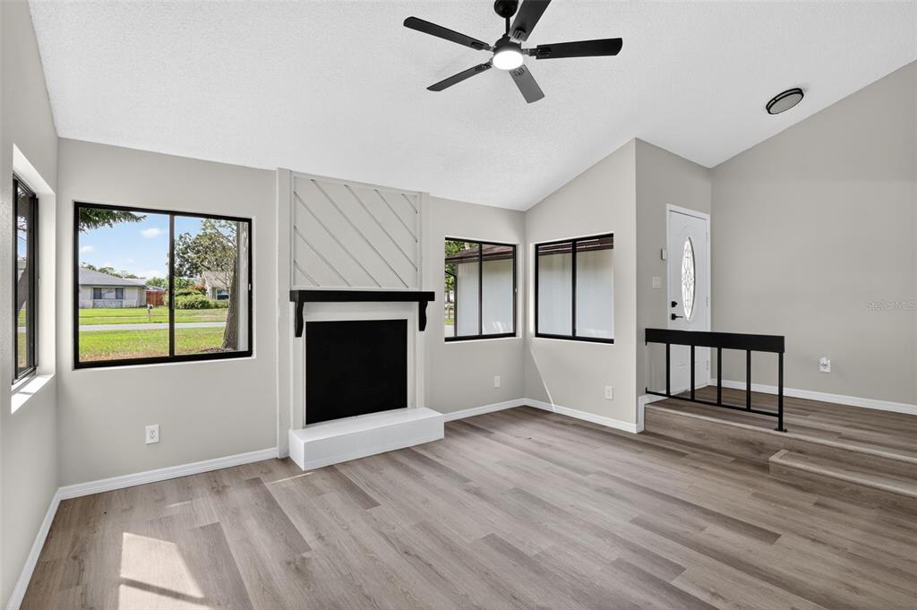 3441 Calgary Lane Mount Dora, FL 32757 - Photo 5 of 20 a view of an empty room with wooden floor and a window