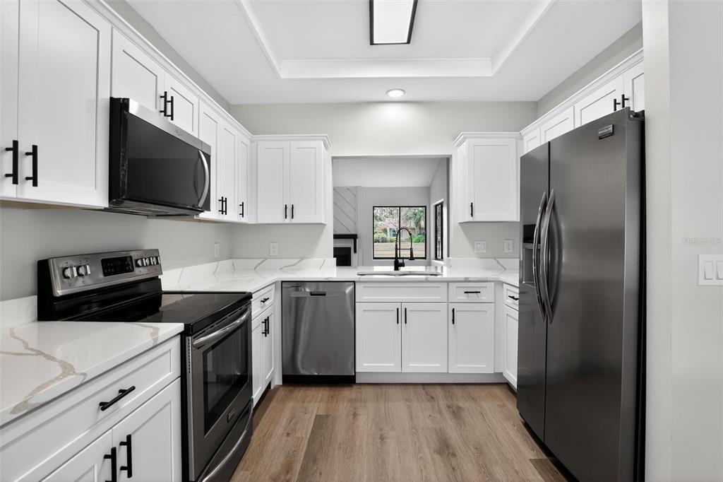 3441 Calgary Lane Mount Dora, FL 32757 - Photo 9 of 20 a kitchen with a sink stove and refrigerator