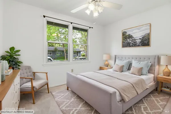 a bedroom with a bed a dresser and a window