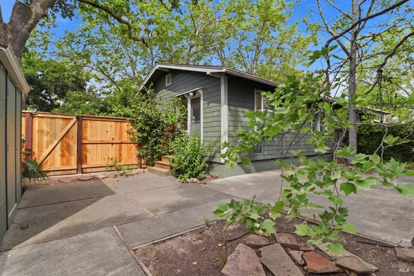 a front view of a house with a tree