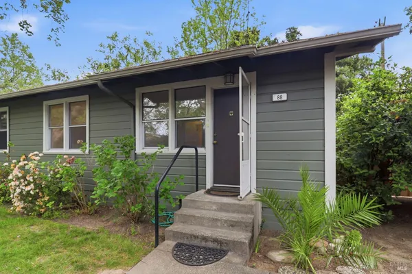 a front view of a house with garden