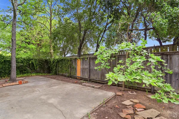 a backyard of a house with fire pit and chairs
