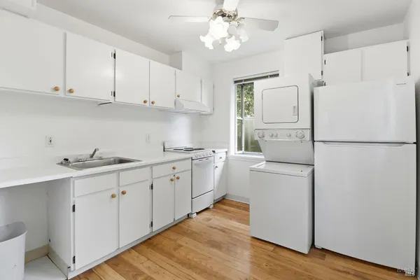 a view of a kitchen with wooden floor