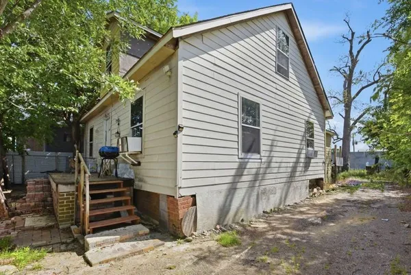 a view of a house with a yard and stairs