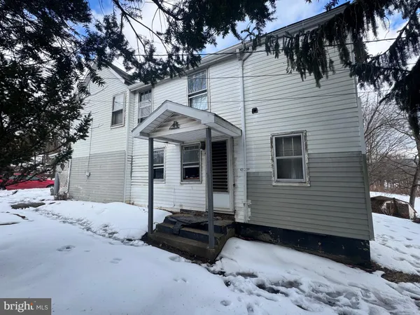 a view of a backyard with a snow on the road