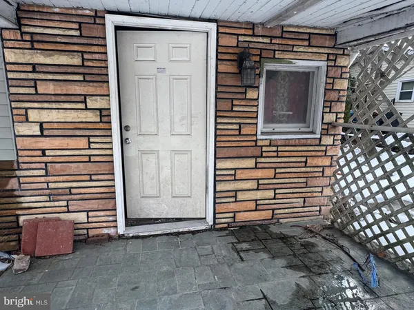 a view of front door and potted plants