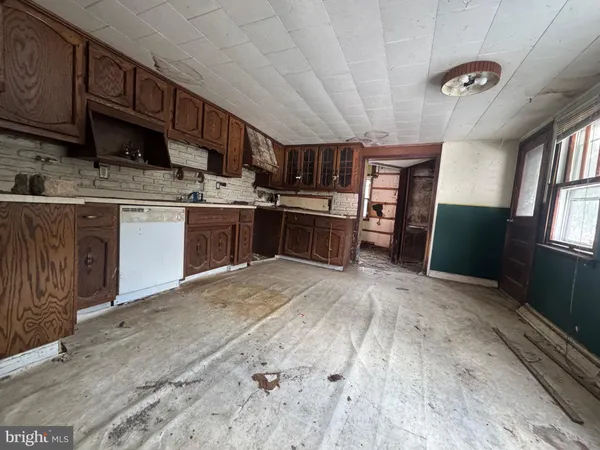 a kitchen with stainless steel appliances granite countertop a refrigerator stove sink and cabinets