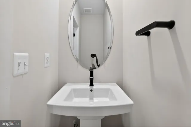 a bathroom with a sink and mirror
