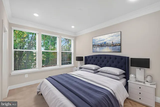 a bedroom with a large bed and a window
