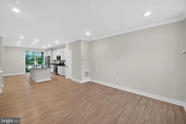a view of a kitchen with a sink and a refrigerator