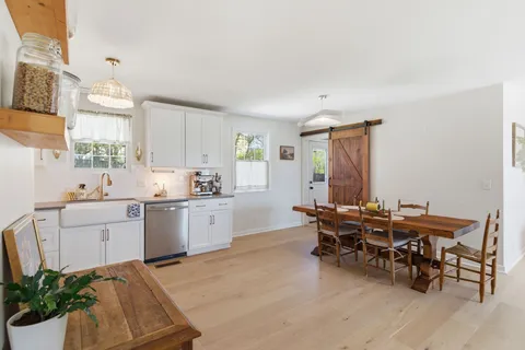 a kitchen with a table and chairs in it