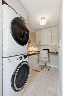 a view of washer and dryer with kitchen in the background