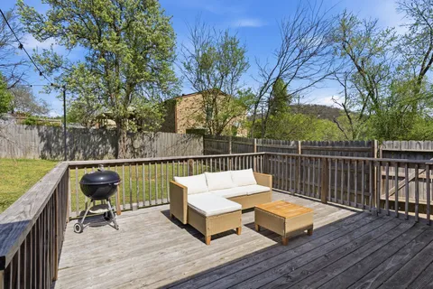 a view of a deck with two chair and wooden floor