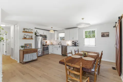 a kitchen with cabinets and wooden floor