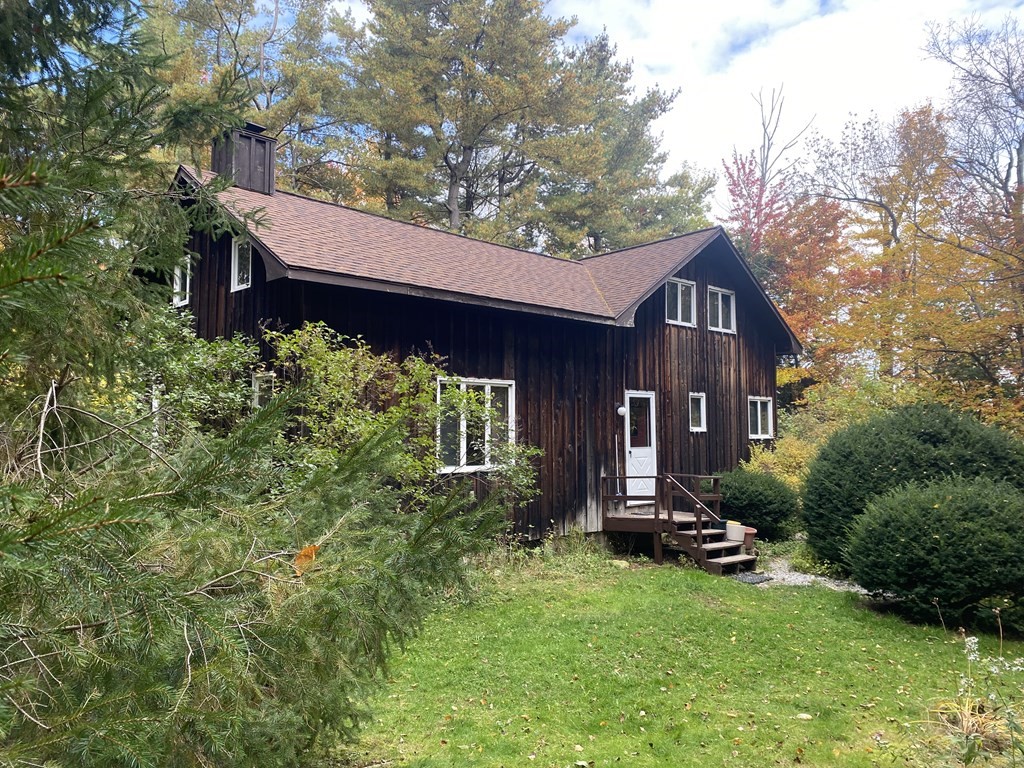 241 Sandisfield Road Sandisfield, MA 01255 - Photo 1 of 35 a view of a house with a small yard plants and large tree
