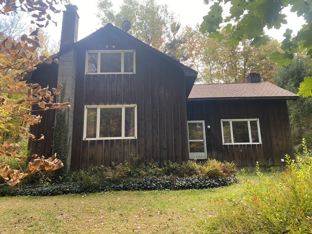 241 Sandisfield Road Sandisfield, MA 01255 - Photo 3 of 35 a front view of a house with a yard and a large tree