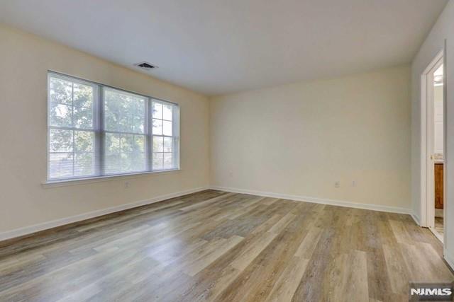 269 Main Street, Unit 2 Little Ferry, NJ 07643 - Photo 14 of 37 an empty room with wooden floor and windows