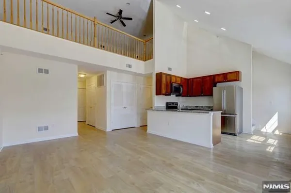 a kitchen with stainless steel appliances a refrigerator and a stove top oven