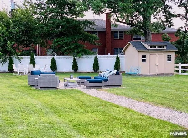 a house view with a sitting space and garden